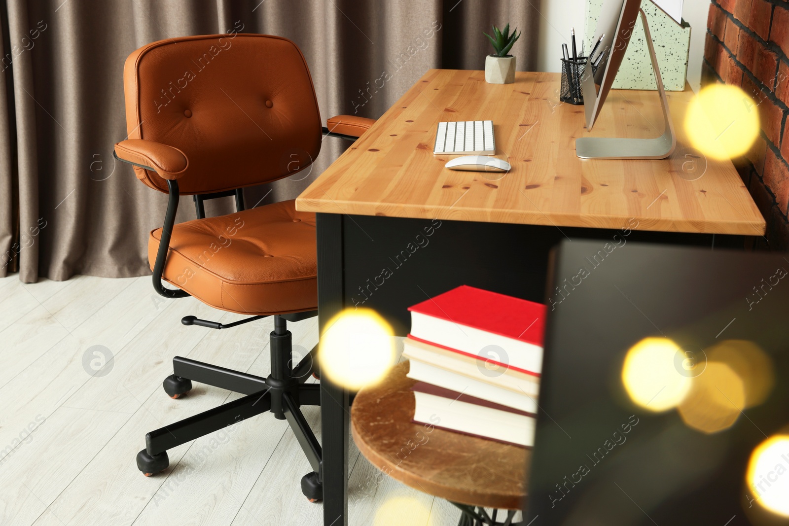 Photo of Comfortable office chair near desk at workplace