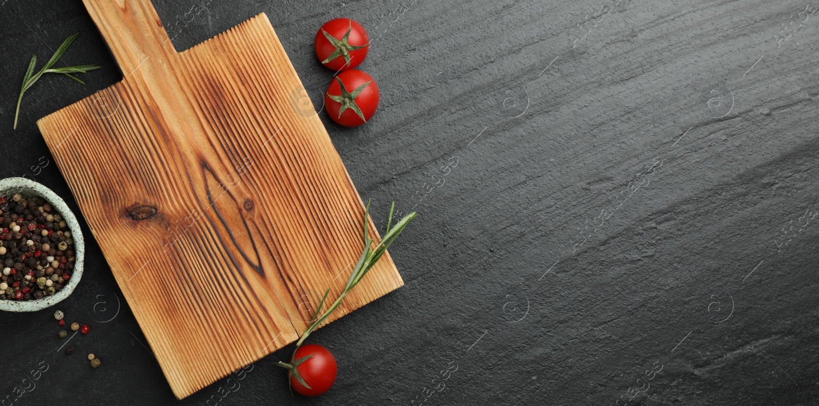 Photo of Wooden cutting board, fresh tomatoes and different spices on grey textured table, flat lay. Space for text