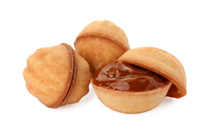 Photo of Delicious nut shaped cookies with boiled condensed milk on white background