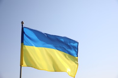 Photo of National flag of Ukraine fluttering on sunny day outdoors