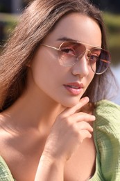 Photo of Beautiful woman in sunglasses outdoors on sunny day