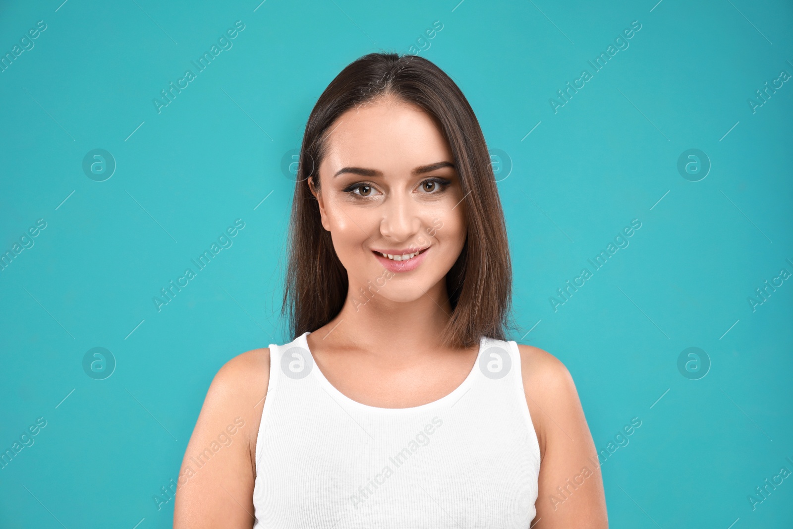 Photo of Beautiful young woman in casual outfit on turquoise background