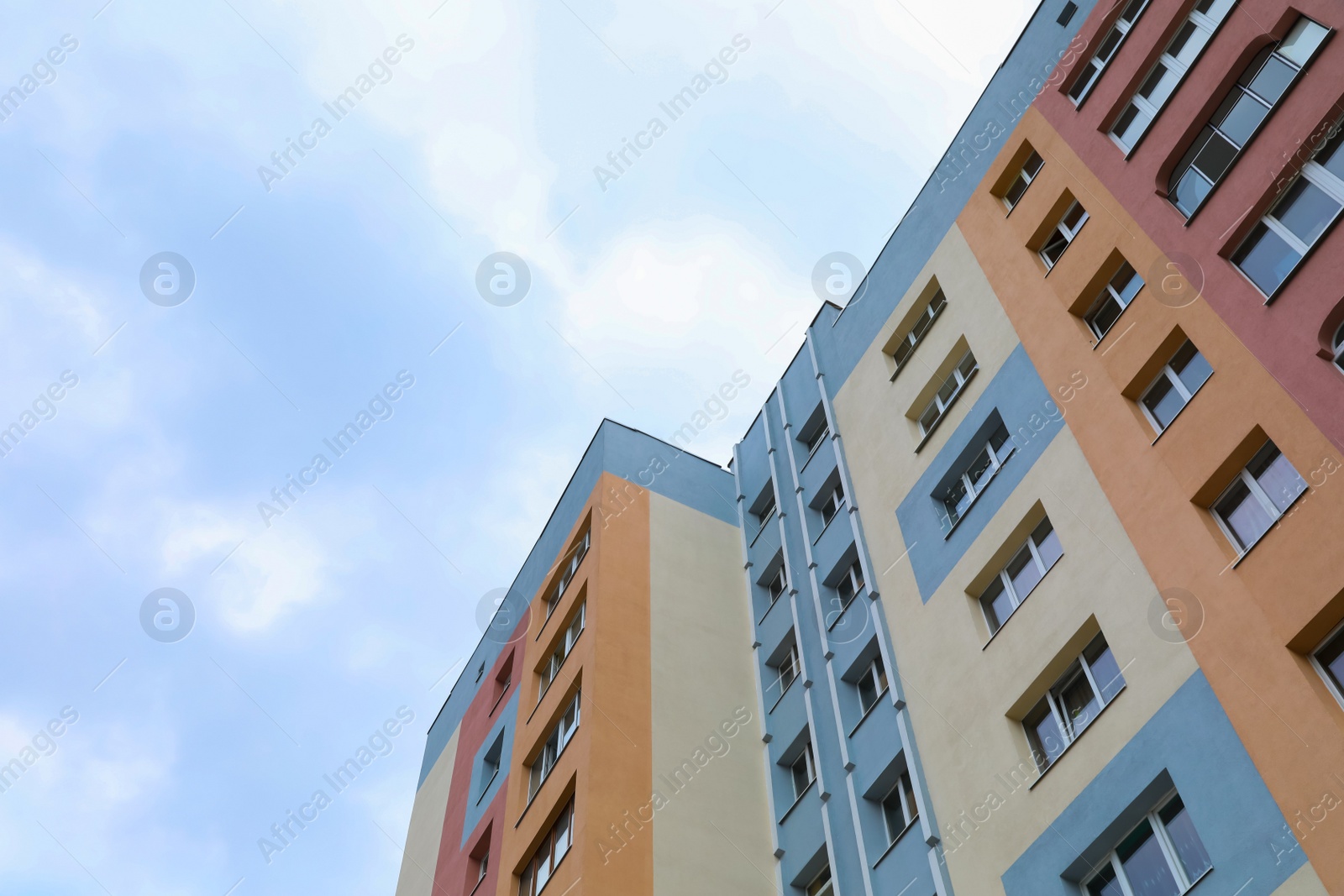 Photo of Multistorey apartment building against cloudy sky, low angle view