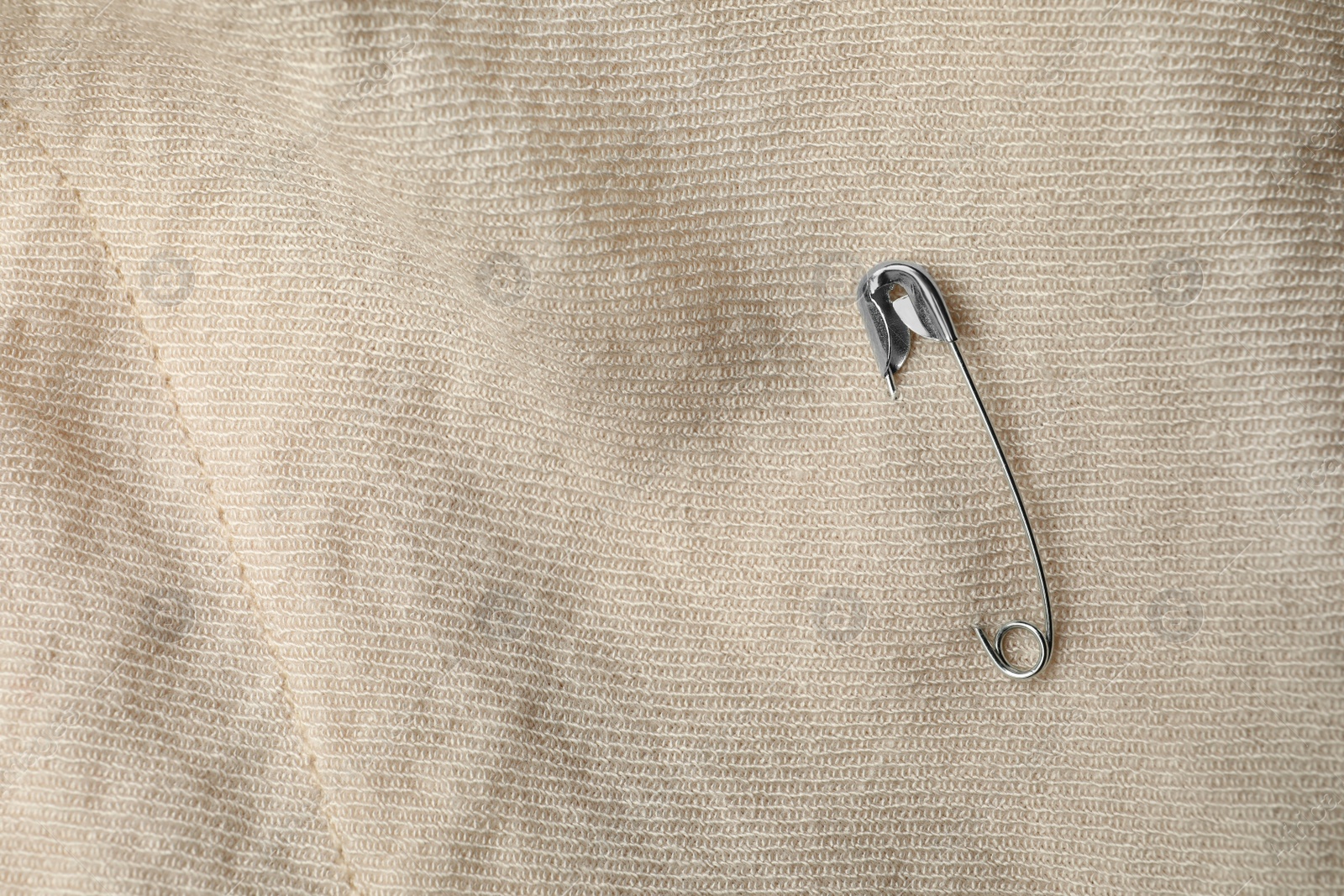 Photo of Top view of metal safety pin on clothing