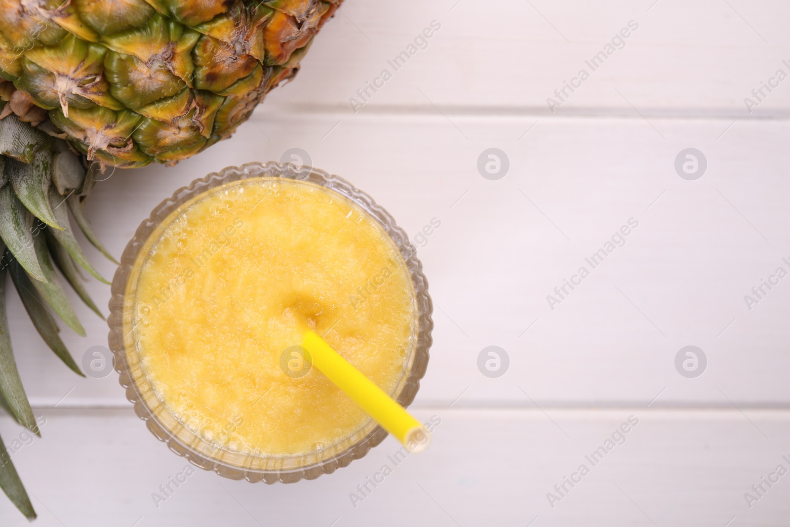 Photo of Tasty pineapple smoothie and fresh fruit on white wooden table, flat lay. Space for text