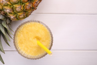 Tasty pineapple smoothie and fresh fruit on white wooden table, flat lay. Space for text