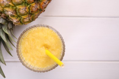 Photo of Tasty pineapple smoothie and fresh fruit on white wooden table, flat lay. Space for text