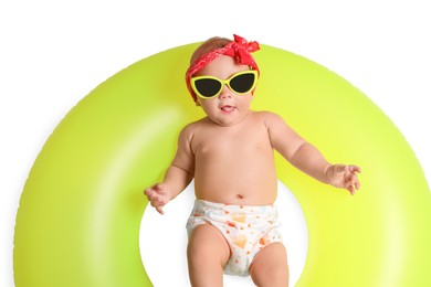 Photo of Cute little baby in sunglasses with inflatable ring on white background, top view