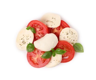 Photo of Delicious Caprese salad with tomatoes, mozzarella cheese, basil leaves and herbs isolated on white, top view