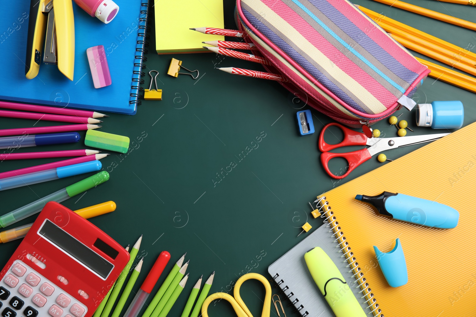 Photo of Flat lay composition with different school stationery on chalkboard surface