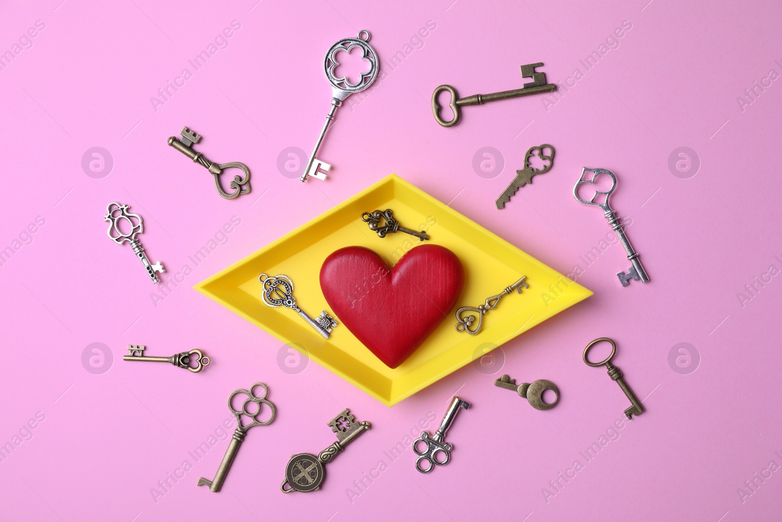 Photo of Flat lay composition with different keys and decorative heart on color background