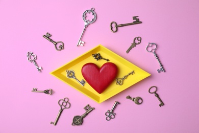Photo of Flat lay composition with different keys and decorative heart on color background
