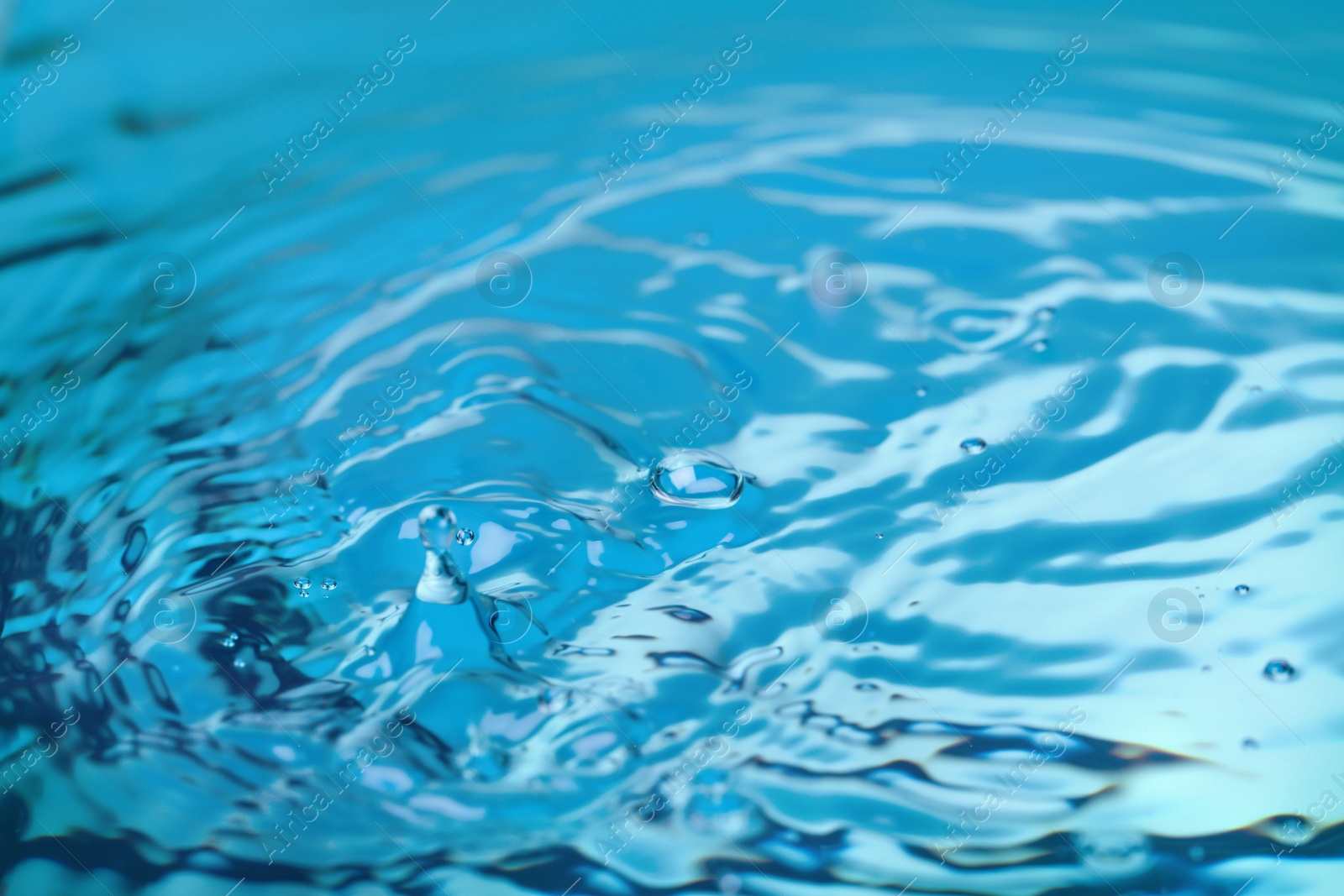 Photo of Splash of blue water with drop, closeup