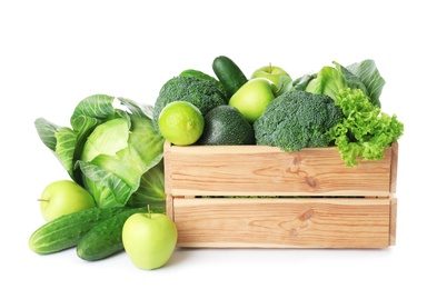 Photo of Wooden crate, fresh green fruits and vegetables on white background