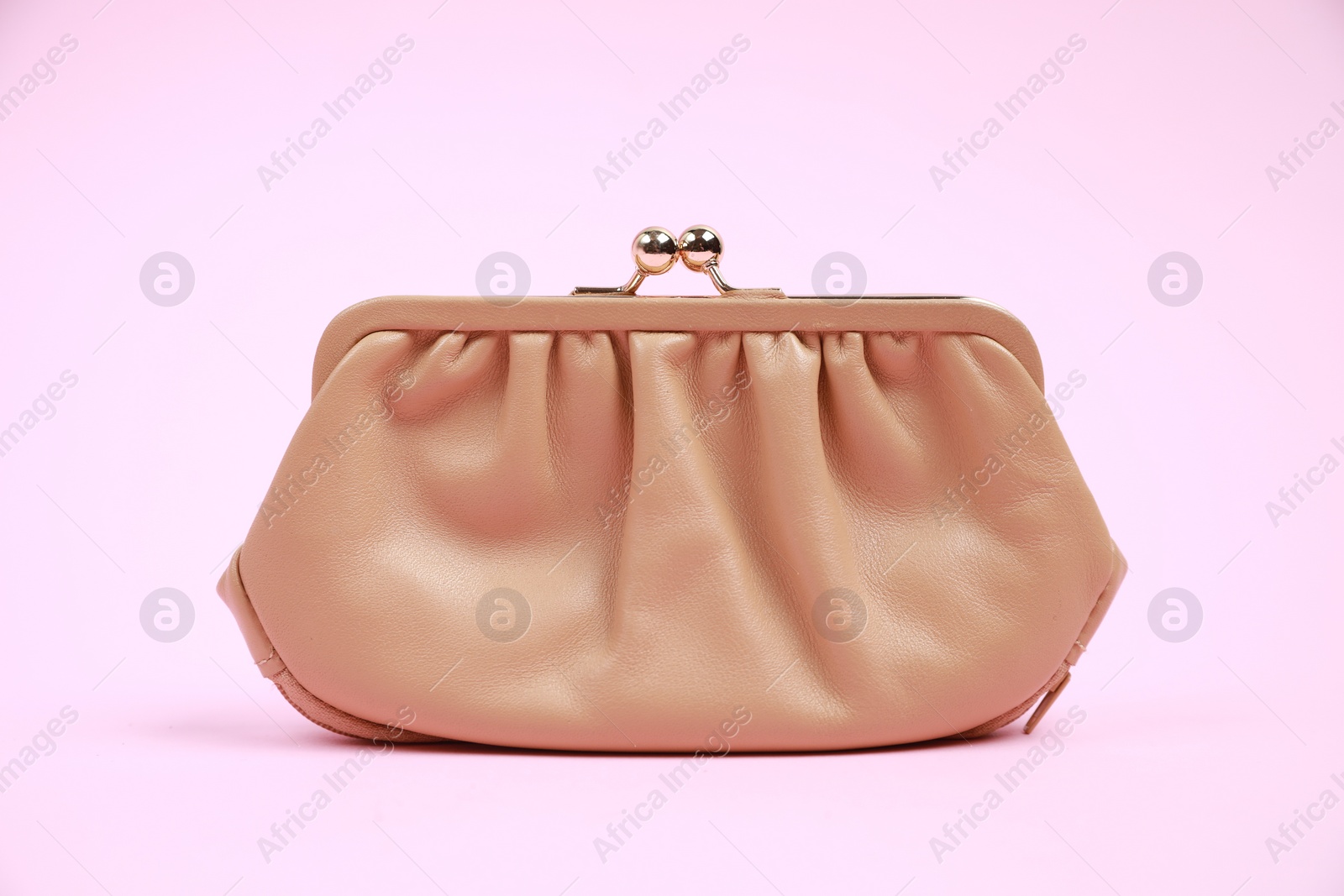 Photo of Stylish beige leather purse on pink background