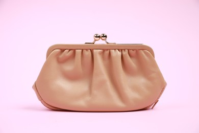 Stylish beige leather purse on pink background