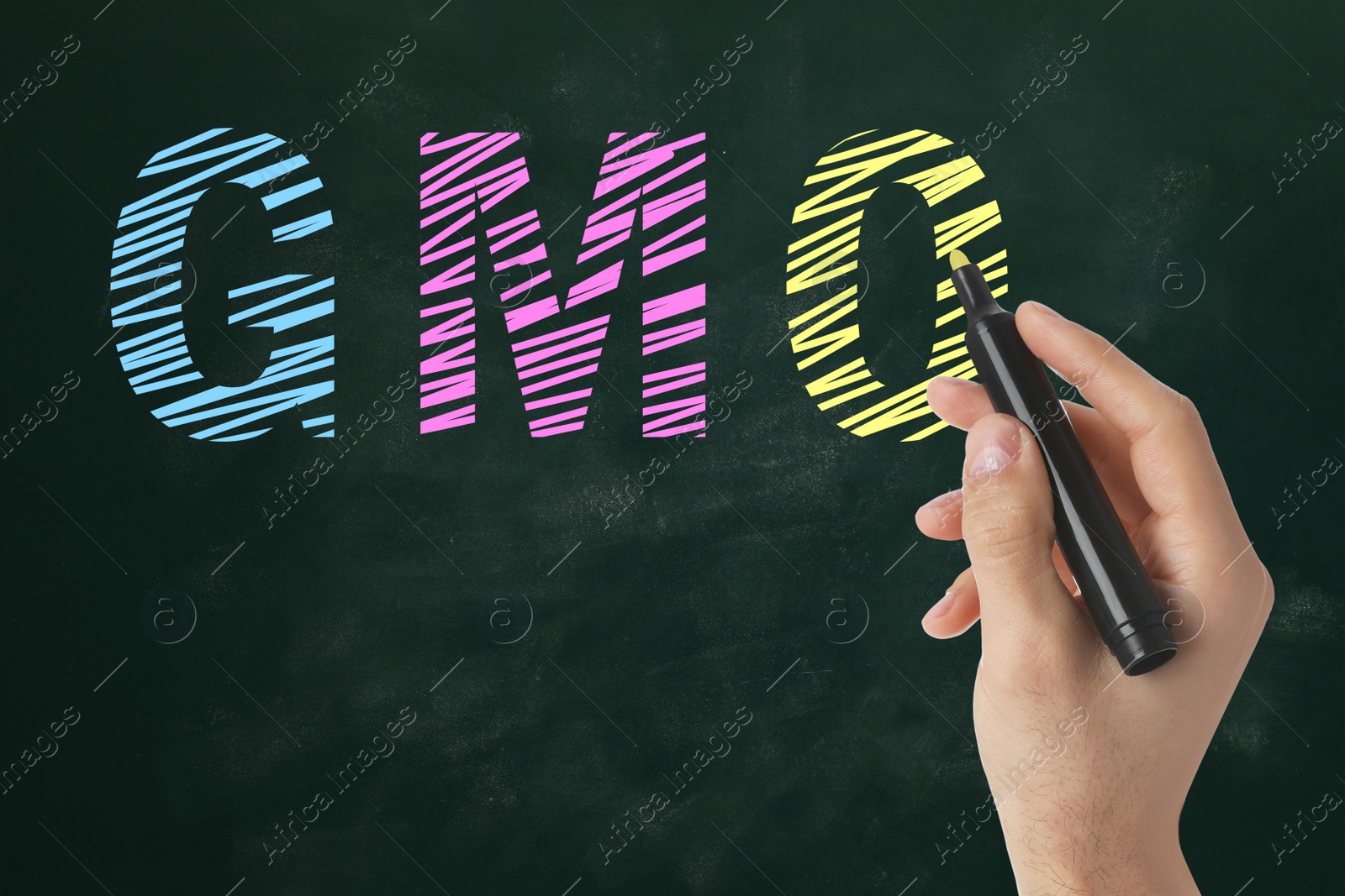 Image of GMO concept. Man with marker near green chalkboard, closeup