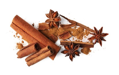 Dry aromatic cinnamon sticks, powder and anise stars isolated on white, top view