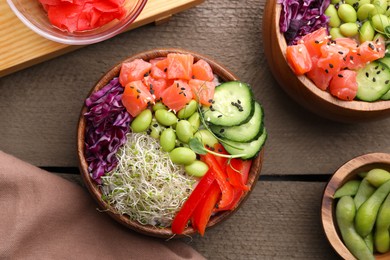 Photo of Delicious poke bowls with vegetables, fish and edamame beans on wooden table, flat lay
