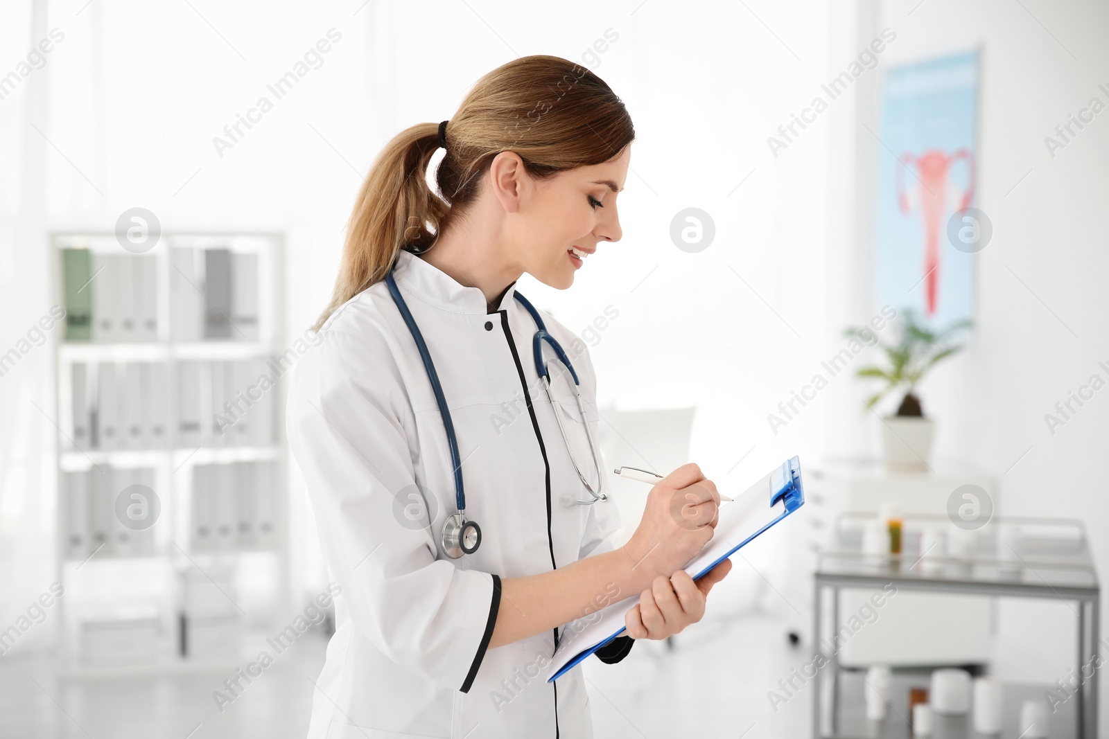 Photo of Female doctor with clipboard in hospital. Gynecology consultation