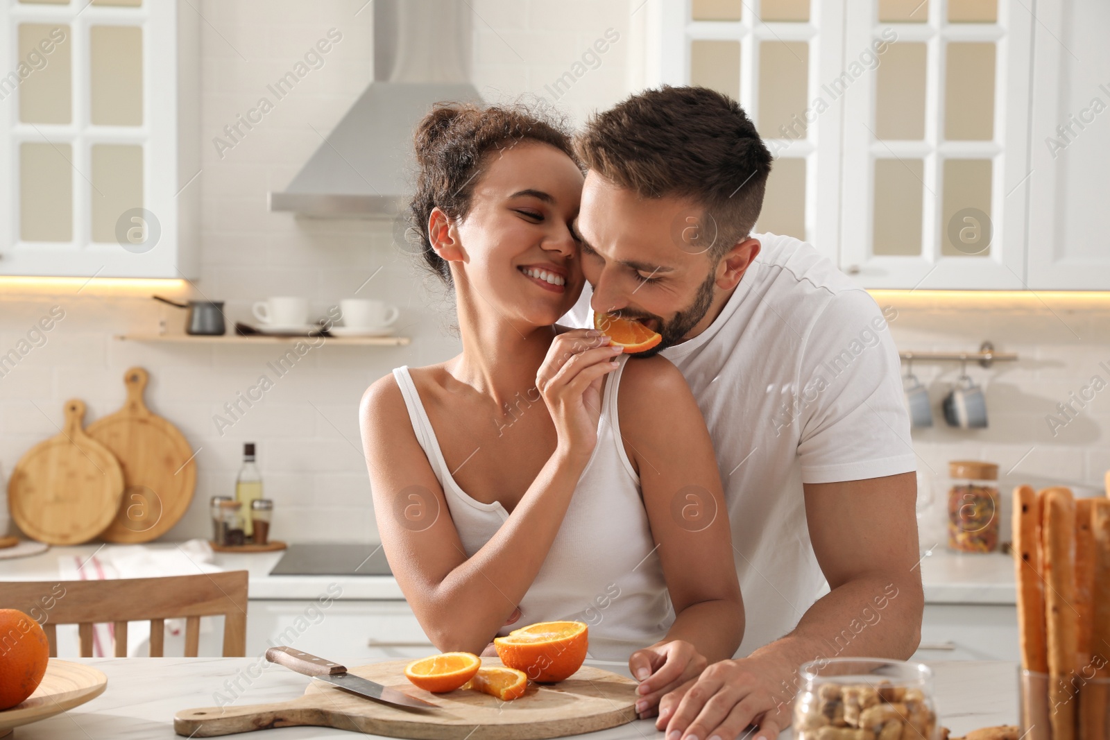 Photo of Lovely couple enjoying time together during breakfast at table in kitchen