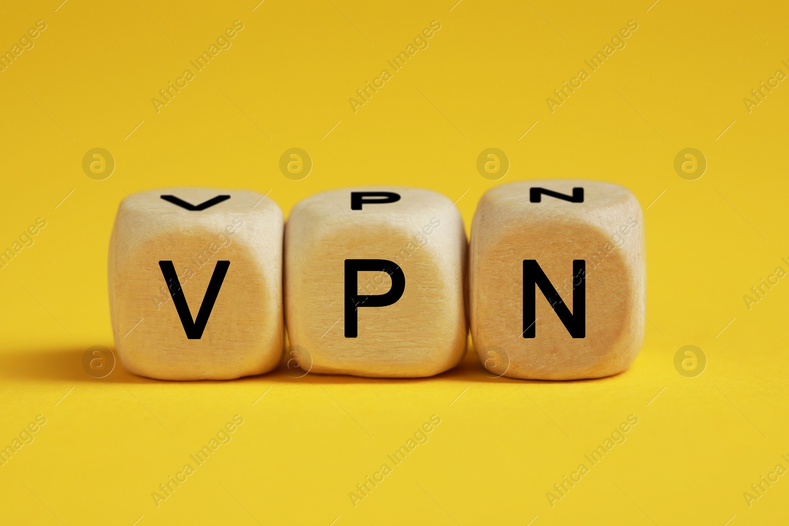 Photo of Wooden beads with acronym VPN on yellow background