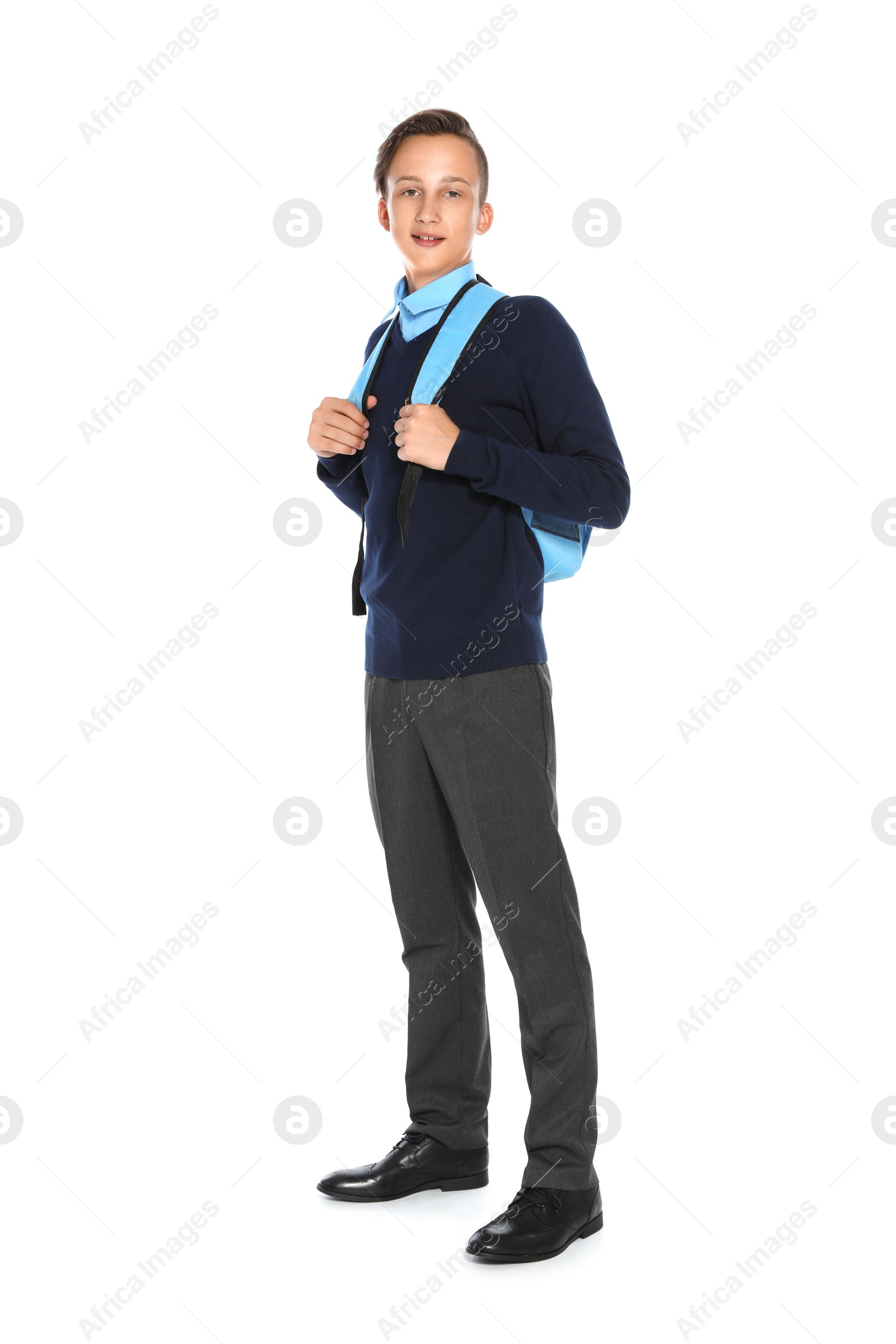 Photo of Teenage boy in stylish school uniform on white background