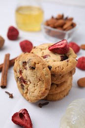 Photo of Cookies with freeze dried fruits, cinnamon, honey and nuts on white table, closeup