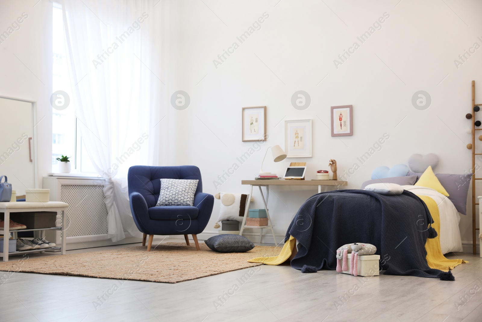 Photo of Modern teenager's room interior with bed and armchair