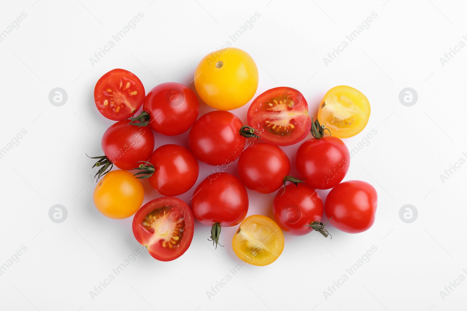 Photo of Different whole and cut tomatoes on white background, flat lay