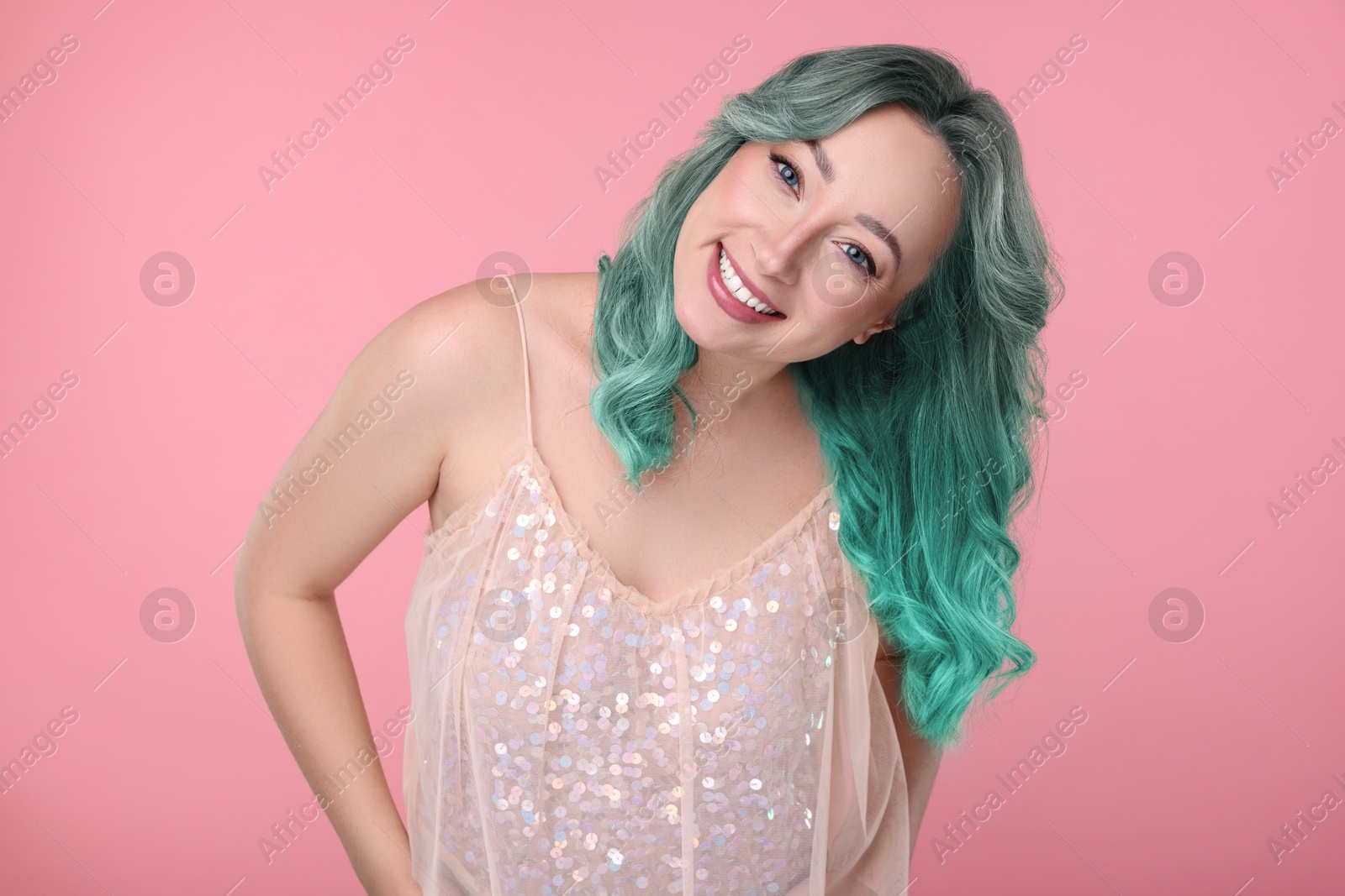 Image of Trendy hairstyle. Young woman with colorful dyed hair on pink background