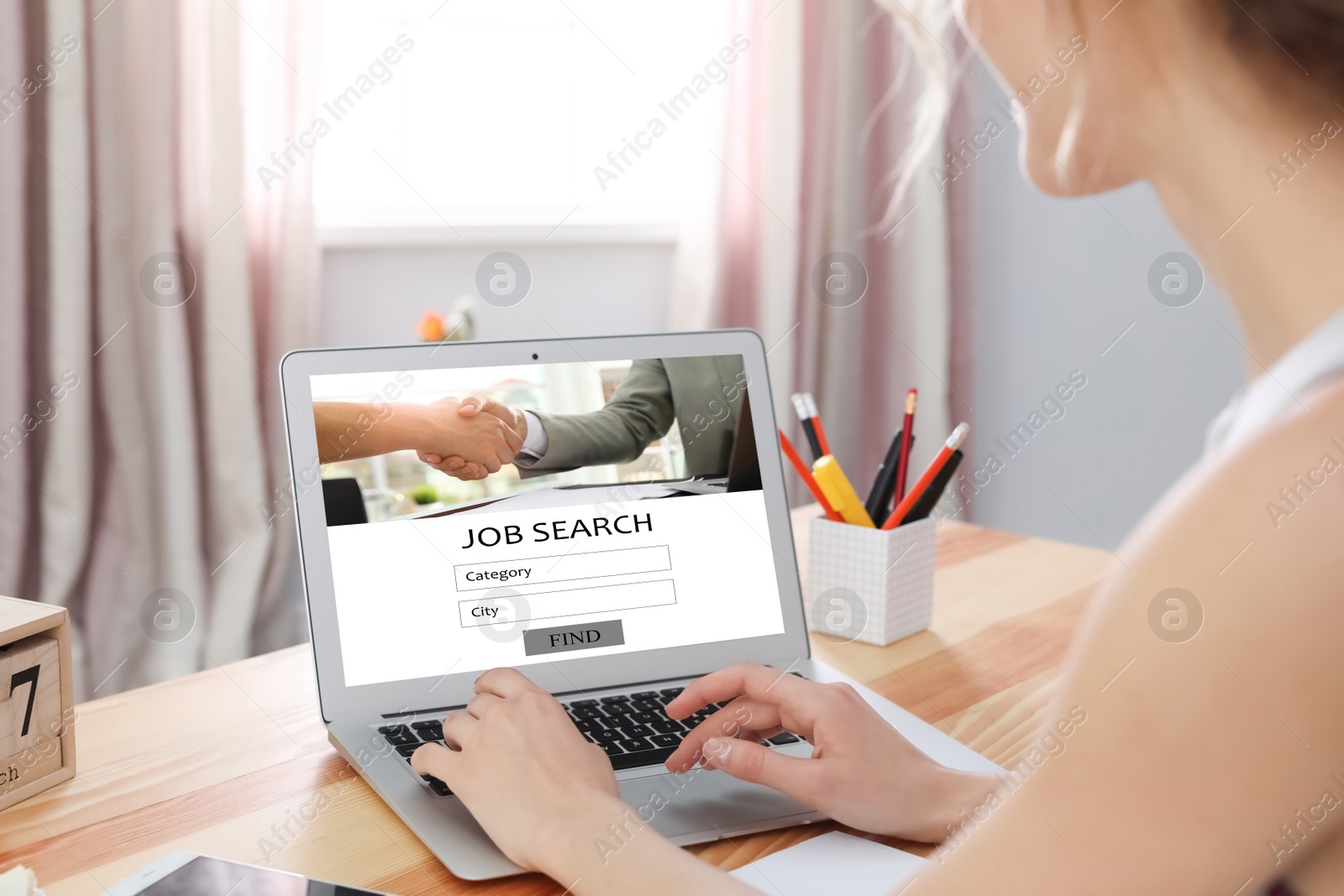 Image of Woman searching job with laptop at wooden table , closeup 