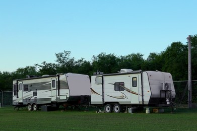 Photo of Travel trailers parked outdoors. Home on wheels