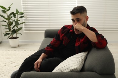 Photo of Sad lonely man on sofa at home