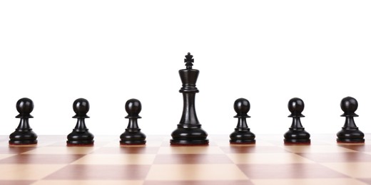 Photo of King among pawns on wooden chess board against white background