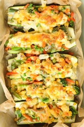 Photo of Baking paper with stuffed zucchinis, top view