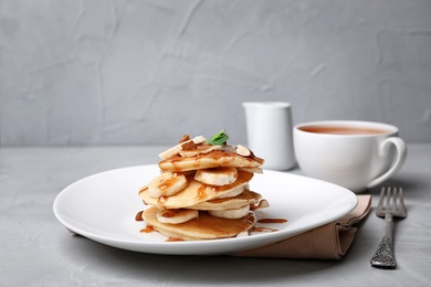 Tasty pancakes with banana on table