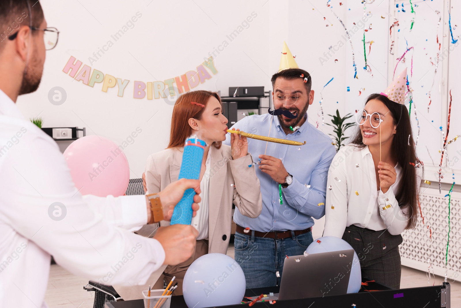 Photo of Coworkers having fun during office party indoors