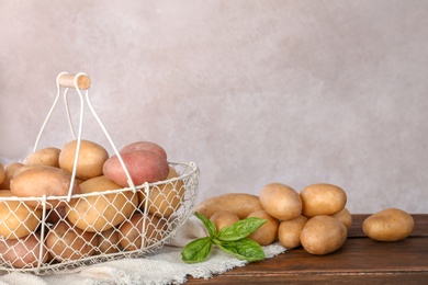 Photo of Composition with fresh organic potatoes and space for text on gray background