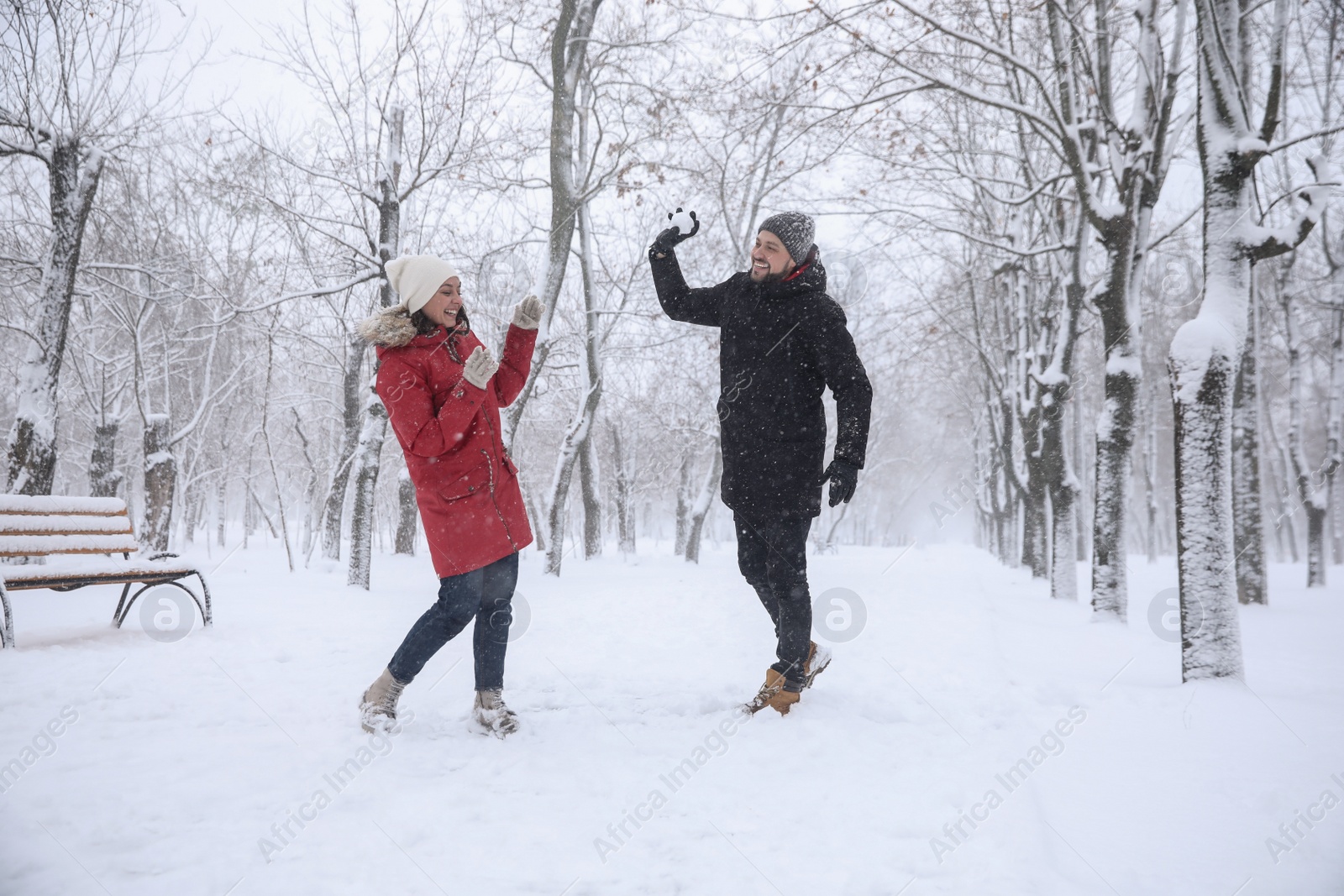 Photo of Happy couple having fun outside on winter day. Christmas vacation