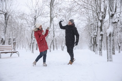 Happy couple having fun outside on winter day. Christmas vacation