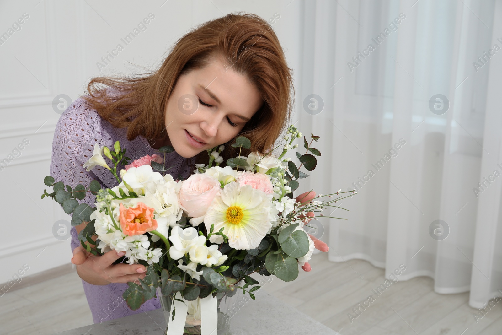 Photo of Beautiful woman with bouquet of flowers indoors. Space for text