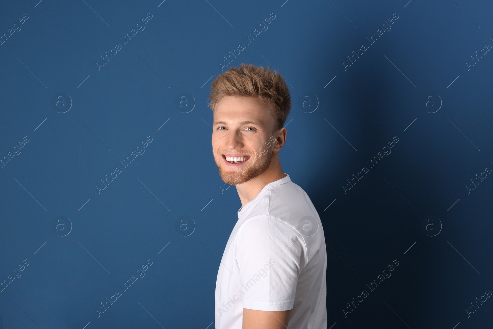 Photo of Portrait of handsome young man on blue background