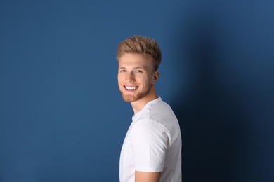 Photo of Portrait of handsome young man on blue background