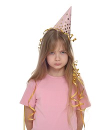 Unhappy little girl in party hat on white background