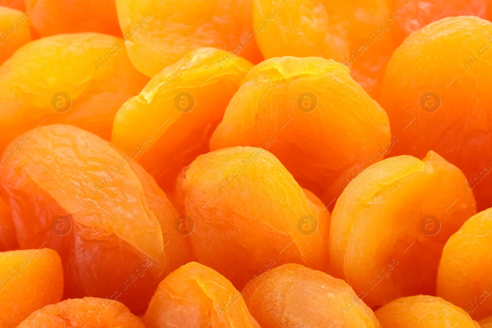 Photo of Tasty apricots as background, closeup. Dried fruit as healthy food