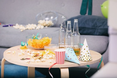 Photo of Wooden table with mess after party indoors