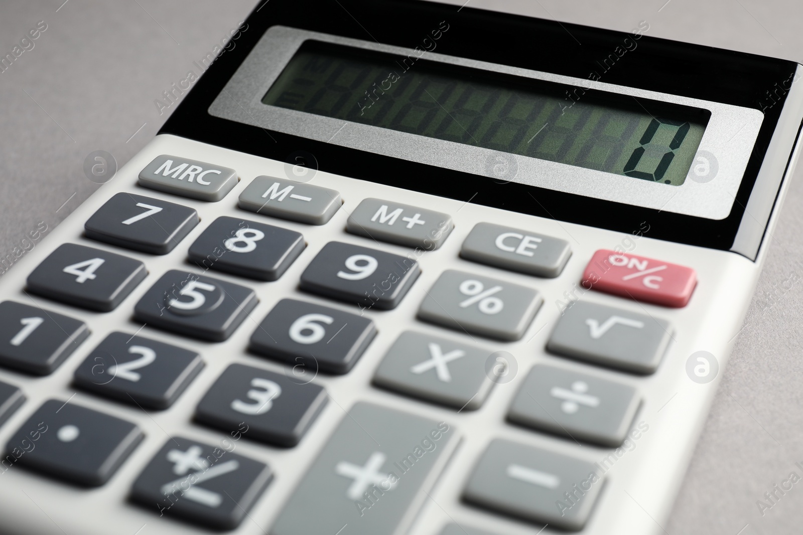 Photo of Calculator on grey background, closeup. Office stationery