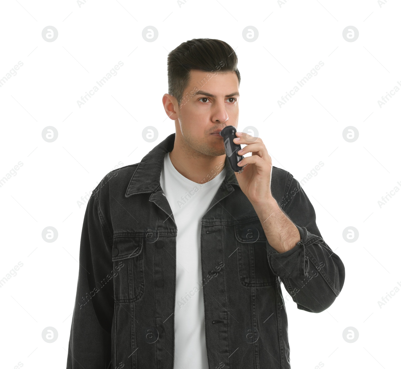 Photo of Man blowing into breathalyzer on white background