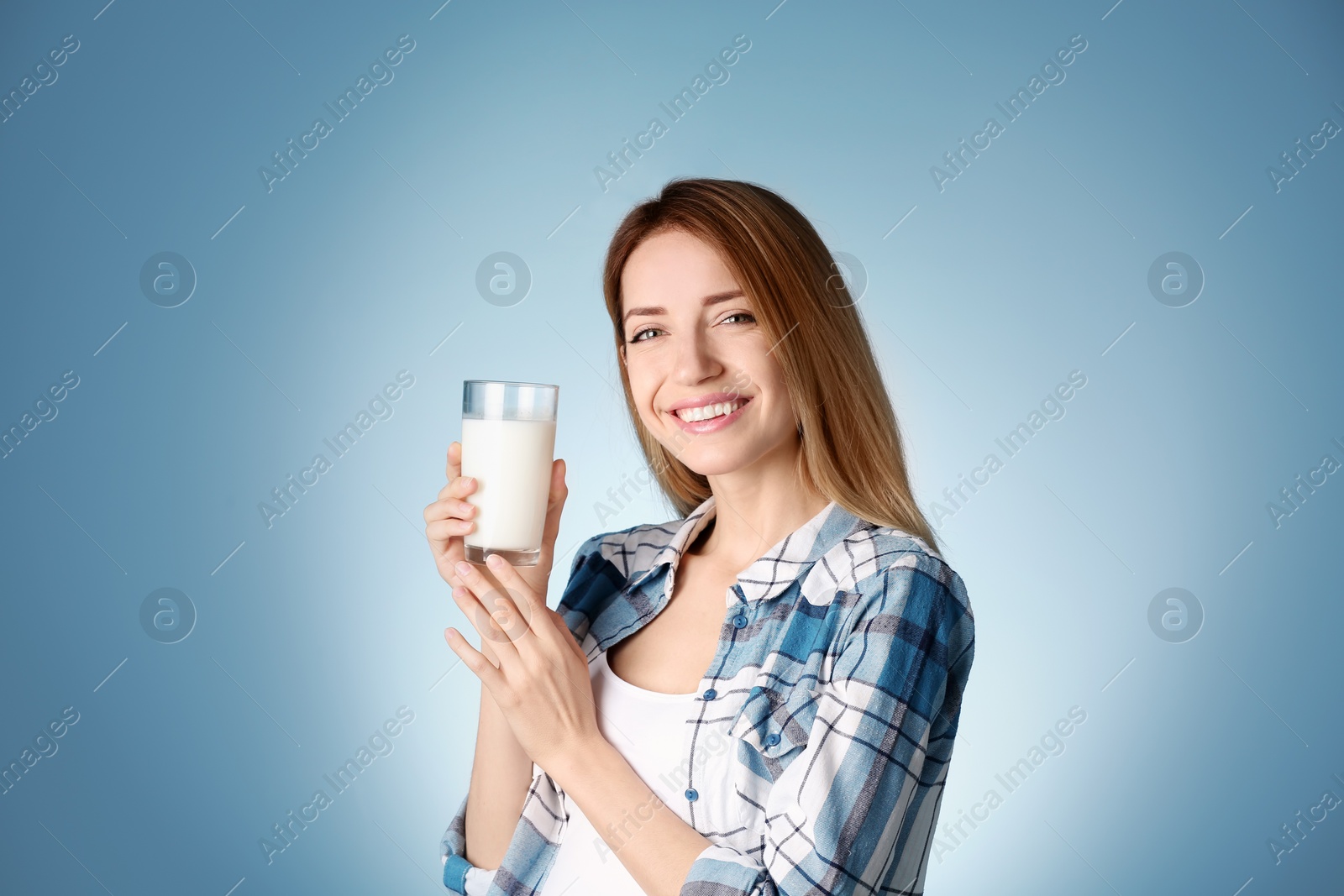 Photo of Beautiful young woman drinking milk on color background